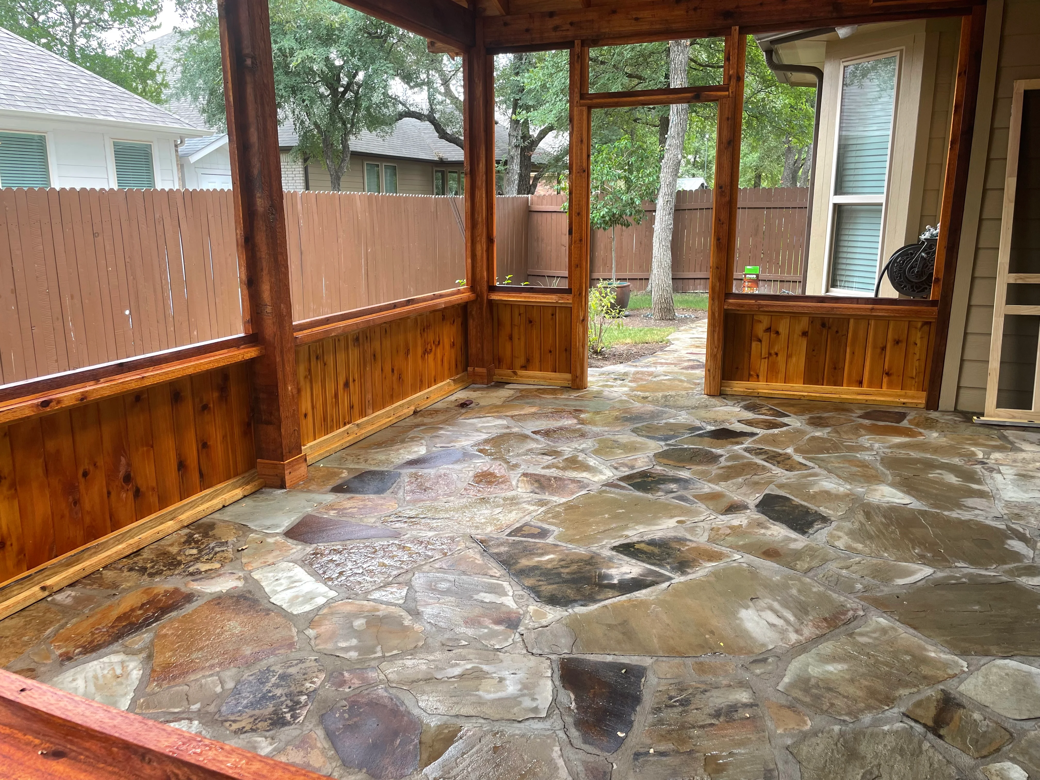 Cedar screened porch with flagstone patio and window panels
